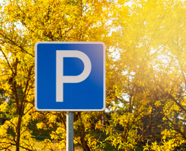 Parking sign with golden trees in the background